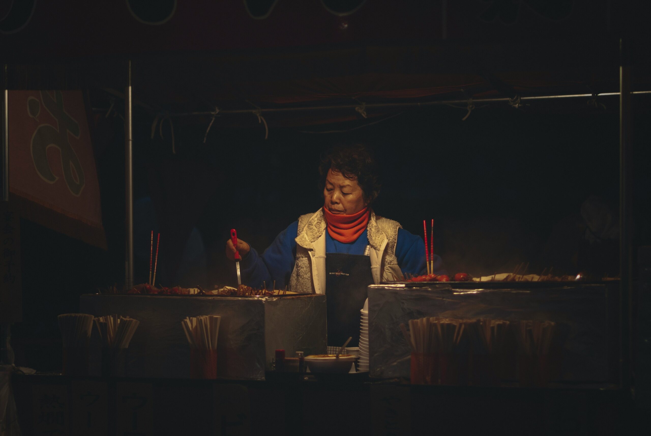 a man standing behind a table